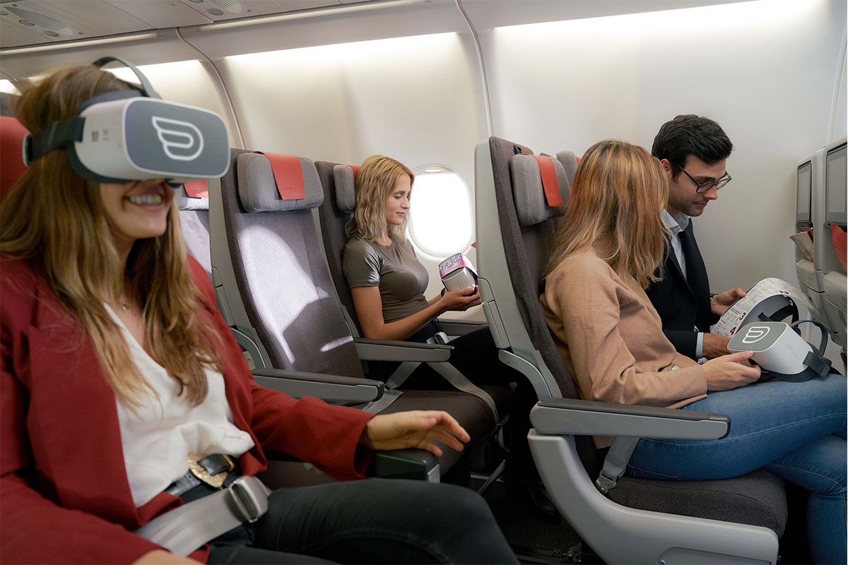 Group of people having a inflight VR experience inside of a Iberia cabin airplane