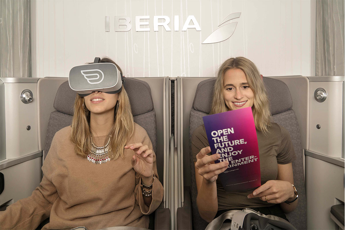 Two womens inside Iberia's cabin having inflight vr experience